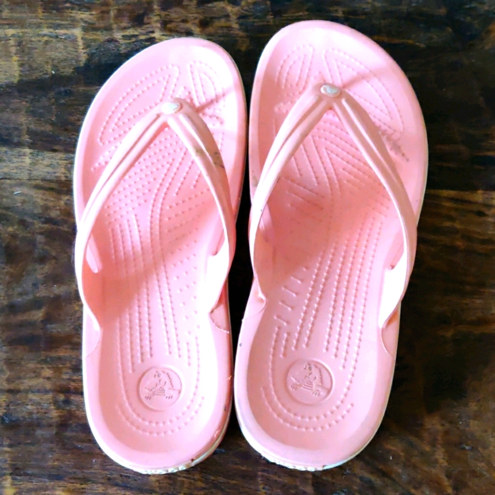 Peachy colored Crocs flip flops